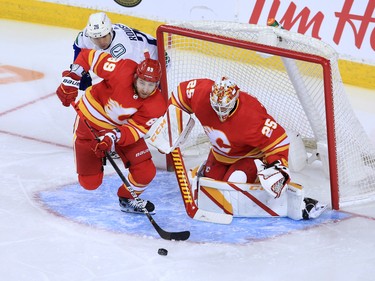 The Calgary Flames’ Nikita Nesterov clears the puck in front of goaltender Jacob Markstrom  during the Calgary Flames NHL home opener against the Vancouver Canucks on Saturday, January 16, 2021. 
Gavin Young/Postmedia