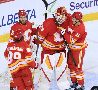 The Calgary Flames congratulate goaltender Jacob Markstrom after a shut out against the Vancouver Canucks during the Calgary Flames NHL home opener on Saturday, January 16, 2021. The Flames won 3-0
Gavin Young/Postmedia