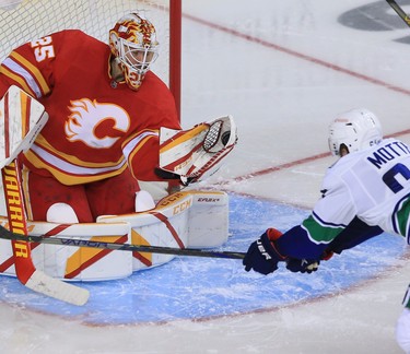 Calgary Flames goaltender Jacob Markstrom snatches the puck in front of Vancouver Canucks forward Tyler Motte during the Calgary Flames NHL home opener on Saturday, January 16, 2021. 
Gavin Young/Postmedia