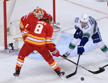 Calgary Flames goaltender Jacob Markstrom and defensemen Christopher Tanev guard the net from Vancouver Canucks forward Nils Hoglander during the Calgary Flames NHL home opener on Saturday, January 16, 2021. 
Gavin Young/Postmedia