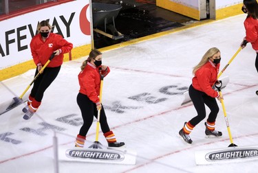 The Calgary Flames wear masks as they clear the ice during a commercial break in the Calgary Flames NHL home opener agains the Vancouver Canucks on Saturday, January 16, 2021. 
Gavin Young/Postmedia