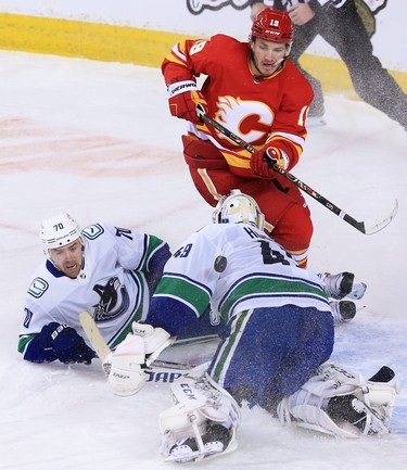 Calgary Flames forward Matthew Tkachuk looks for a rebound as the puck bounces around Vancouver Canucks goaltender Braden Holtby and forward Tanner Pearson during the Calgary Flames NHL home opener on Saturday, January 16, 2021. 
Gavin Young/Postmedia