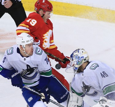Calgary Flames forward Matthew Tkachuk looks for a rebound as the puck bounces around Vancouver Canucks goaltender Braden Holtby and forward Tanner Pearson during the Calgary Flames NHL home opener on Saturday, January 16, 2021. 
Gavin Young/Postmedia