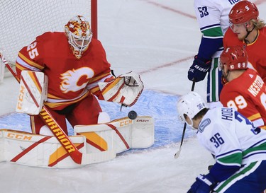 Calgary Flames goaltender Jacob Markstrom snatches the puck  during the Calgary Flames NHL home opener against the Vancouver Canucks on Saturday, January 16, 2021. 
Gavin Young/Postmedia