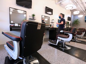 MVP Modern Barbers owner and barber David Shields completes some final preparations in his Kensington shop on Sunday, Jan. 17, 2021. Barbers and hairstylists are among a number of personal services that can reopen in Alberta on Monday.