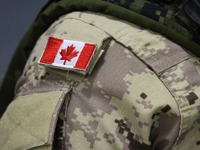 A Canadian flag on a member of the Canadian forces that are leaving from CFB Trenton, in Trenton, Ont., on Thursday, Oct. 16, 2014.