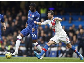 Crystal Palace's Luka Milivojevic, right, challenges Chelsea's Fikayo Tomori during their English Premier League soccer match between Chelsea and Crystal Palace at Stamford Bridge stadium in London, Saturday, Nov. 9, 2019.
