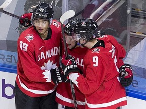 Canada's Jakob Pelletier (12) celebrates his goal with teammates Quinton Byfield (19) and Connor Zary (9) against Switzerland during second period IIHF World Junior Hockey Championship action on Tuesday, Dec. 29, 2020 in Edmonton. Greg Southam-Postmedia