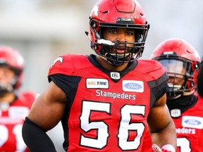 Jameer Thurman of the Calgary Stampeders runs onto the field during player introductions before facing the BC Lions in CFL football on Saturday, October 13, 2018. Al Charest/Postmedia