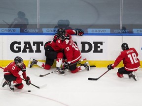 Dejected members of Team Canada — Cole Perfetti (11) Bowen Byram (4) Jakob Pelletier (12) and Peyton Krebs (18) — after losing to the United States at the IIHF World Junior Hockey Championship gold-medal game on Tuesday, Jan. 5, 2021 in Edmonton.