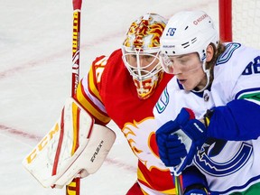 Jan 16, 2021; Calgary, Alberta, CAN; Vancouver Canucks center Adam Gaudette (96) screens Calgary Flames goaltender Jacob Markstrom (25) during the third period at Scotiabank Saddledome. Mandatory Credit: Sergei Belski-USA TODAY Sports ORG XMIT: IMAGN-444931