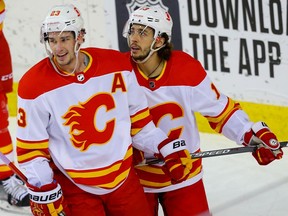 Calgary Flames Sean Monahan and Johnny Gaudreau after a Gaudreau goal during an intrasquad game at the Saddledome in Calgary on Monday, Jan. 11, 2021.
