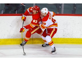 Nikita Nesterov (right) battles Adam Ruzicka during the Calgary Flames’ intrasquad game at the Saddledome in Calgary on Thursday, Jan. 7, 2021.