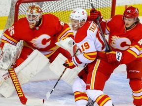 Matthew Tkachuk battles Luke Philp in front of goalie Jacob Markstrom during the Calgary Flames’ intrasquad game at the Saddledome in Calgary on Thursday, Jan. 7, 2021.
