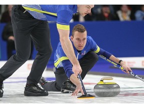Alberta skip Brendan Bottcher throws a rock against against Newfoundland and Labrador as Brad Thiessen sweeps during the final of the 2020 Tim Hortons Brier in Kingston on Sunday March 8, 2020. Ian MacAlpine/Kingston Whig-Standard/ Postmedia Network