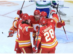 The Calgary Flames celebrate Sean Monahan's first-period goal on the Vancouver Canucks during the Calgary Flames' NHL home opener on Saturday, January 16, 2021.