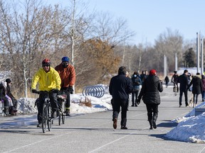 Calgarians took advantage of the pleasant weather to spend the afternoon on the Bow River pathway in East Village on Saturday, Feb. 20, 2021.