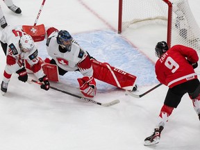 Canada's Connor Zary takes a shot on Swiss goaltender Noah Patenaude during the 2021 IIHF World Junior Championship at Edmonton's Rogers Place in this photo from on December 2020.