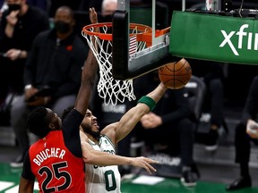 Jayson Tatum of the Boston Celtics takes a shot against Chris Boucher of the Toronto Raptors during the third quarter at TD Garden on February 11, 2021 in Boston, Massachusetts.