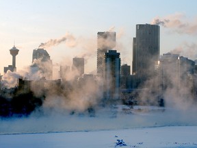 A heavy fog is seen lifting from the Bow River mixing with the sunset to create a picturesque view from the 12th St. Bridge in Inglewood during a cold afternoon in Calgary. Sunday, Feb. 7, 2021.