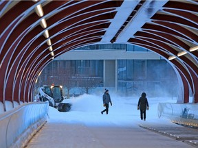A cyclist crosses the snowy Peace Bridge as Calgarians awoke to fresh snow on Wednesday, February 3, 2021.