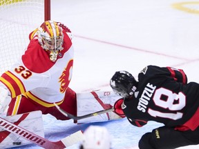 CP-Web.  Calgary Flames goaltender David Rittich (33) makes a save on a shot from Ottawa Senators left wing Tim Stutzle (18) during second period NHL action in Ottawa on Saturday, Feb. 27, 2021.