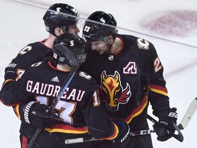 Feb 6, 2021; Calgary, Alberta, CAN; Calgary Flames forward Johnny Gaudreau (13) celebrates his third period goal against the Edmonton Oilers with teammates at Scotiabank Saddledome. Mandatory Credit: Candice Ward-USA TODAY Sports ORG XMIT: IMAGN-445088