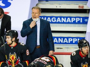 Feb 17, 2021; Calgary, Alberta, CAN; Calgary Flames head coach Geoff Ward (top, right) reacts from the bench during the first period against the Vancouver Canucks at Scotiabank Saddledome. Mandatory Credit: Sergei Belski-USA TODAY Sports