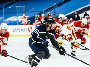 Feb 4, 2021; Winnipeg, Manitoba, CAN;  Winnipeg Jets forward Kyle Connor (81) skates away from Calgary Flames forward Mikael Backlund (11) during the second period at Bell MTS Place. Mandatory Credit: Terrence Lee-USA TODAY Sports ORG XMIT: IMAGN-445072