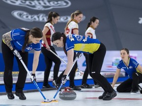 Team Alberta third Kate Cameron (L) and  second Taylor McDonald sweep lead Rachel Brown's rock in the Semi Final, the Scotties Tournament of Hearts 2021, the Canadian Women's Curling Championship.



Special to Postmedia /Andrew Klaver /POOL