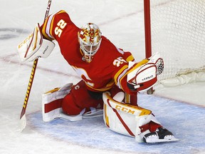 Calgary Flames goalie Jacob Markstrom makes a glove save on a Vancouver Canucks shot at the Scotiabank Saddledome in Calgary on Monday, Jan. 18, 2021.