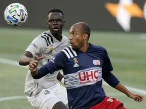 Montreal Impact’s Karifa Yao, left, and New England Revolution’s Teal Bunbury, keep their eyes on the ball during an MLS match in Foxborough, Mass., on Sept. 23, 2020.