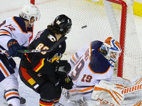 Calgary Flames winger Andrew Mangiapane watches the puck go into the net after a goal by Mikael Backlund on goalie Mikko Koskinen of the Edmonton Oilers during NHL hockey in Calgary on Saturday February 6, 2021. Al Charest / Postmedia