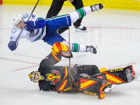 Calgary Flames goalie Jacob Markstrom collides with Tanner Pearson of the Vancouver Canucks during NHL hockey in Calgary on Wednesday February 17, 2021.