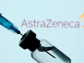 A vial and syringe in front of an AstraZeneca logo in this illustration taken Jan. 11, 2021.