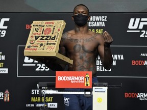 Israel Adesanya of Nigeria poses on the scale during the UFC 259 weigh-in on Friday.