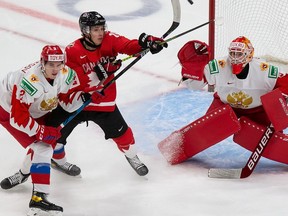 EDMONTON, AB - JANUARY 04: Dylan Holloway #10 of Canada battles against Yan Kuznetsov #2 and goaltender Yaroslav Askarov #1 of Russia during the 2021 IIHF World Junior Championship semifinals at Rogers Place on January 4, 2021 in Edmonton, Canada.