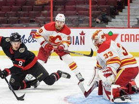 OTTAWA, ON - MARCH 1:  Josh Norris #9 of the Ottawa Senators shoots the puck against David Rittich #33 of the Calgary Flames as Nikita Nesterov #89 looks on at Canadian Tire Centre on March 1, 2021 in Ottawa, Ontario, Canada.