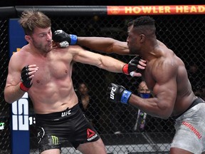 Francis Ngannou punches Stipe Miocic in their heavyweight championship fight during UFC 260 at the UFC Apex in Las Vegas on Saturday, March 27, 2021.