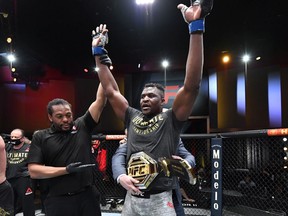 Francis Ngannou celebrates after knocking out Stipe Miocic for the heavyweight championship during UFC 260 at the UFC Apex in Las Vegas on Saturday, March 27, 2021.