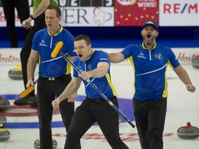 From right: Team Alberta's Darren Moulding, Brad Thiessen and lead Karrick Martin celebrate after defeating Saskstachewan in the semifinal.