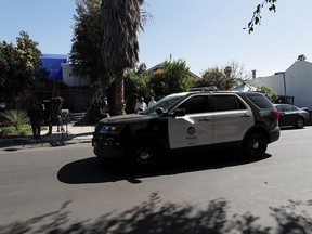 A police car stands at the site where Lady Gaga's dog walker was shot and two of her dogs were stolen in Los Angeles February 25, 2021.