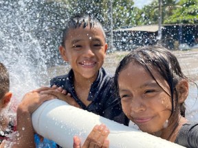 Children enjoying fresh water from a new well drill in Guatemala.
