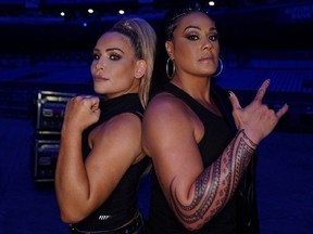 Nattie with Tamina (right) showing off her new tattoo backstage at Smackdown. Her tattoo represents her family and her heritage.