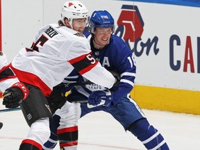 Senators defenceman Mike Reilly checks Maple Leafs winger Mitch Marner in one of their many meetings this season. GETTY IMAGES