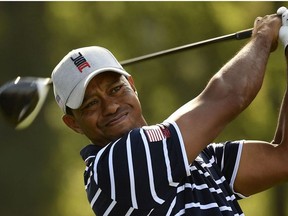 In this file photo US golfer Tiger Woods plays a tee shot during his fourball match on the first day of the 42nd Ryder Cup at Le Golf National Course at Saint-Quentin-en-Yvelines, south-west of Paris on September 28, 2018.
