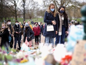 Women mourn at a memorial site at the Clapham Common Bandstand, following the kidnap and murder of Sarah Everard, in London, Britain March 14, 2021.