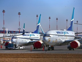 WestJet Boeing 737 aircraft are seen in storage at the Calgary International Airport on Tuesday, March 23, 2021.