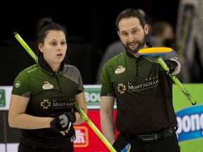 Emilie Desjardins and her father, Robert Desjardins, look at their options during a game against Jennifer Jones and Brent Laing at the Home Hardware Canadian Mixed Doubles Curling Championship at the Markin MacPhail Centre in Calgary on Thursday, March 18, 2021.
