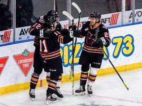 The Calgary Hitmen celebrate during their 7-4 win over the Lethbridge Hurricanes at the Enmax Centre in Lethbridge on Sunday, March 21, 2021.